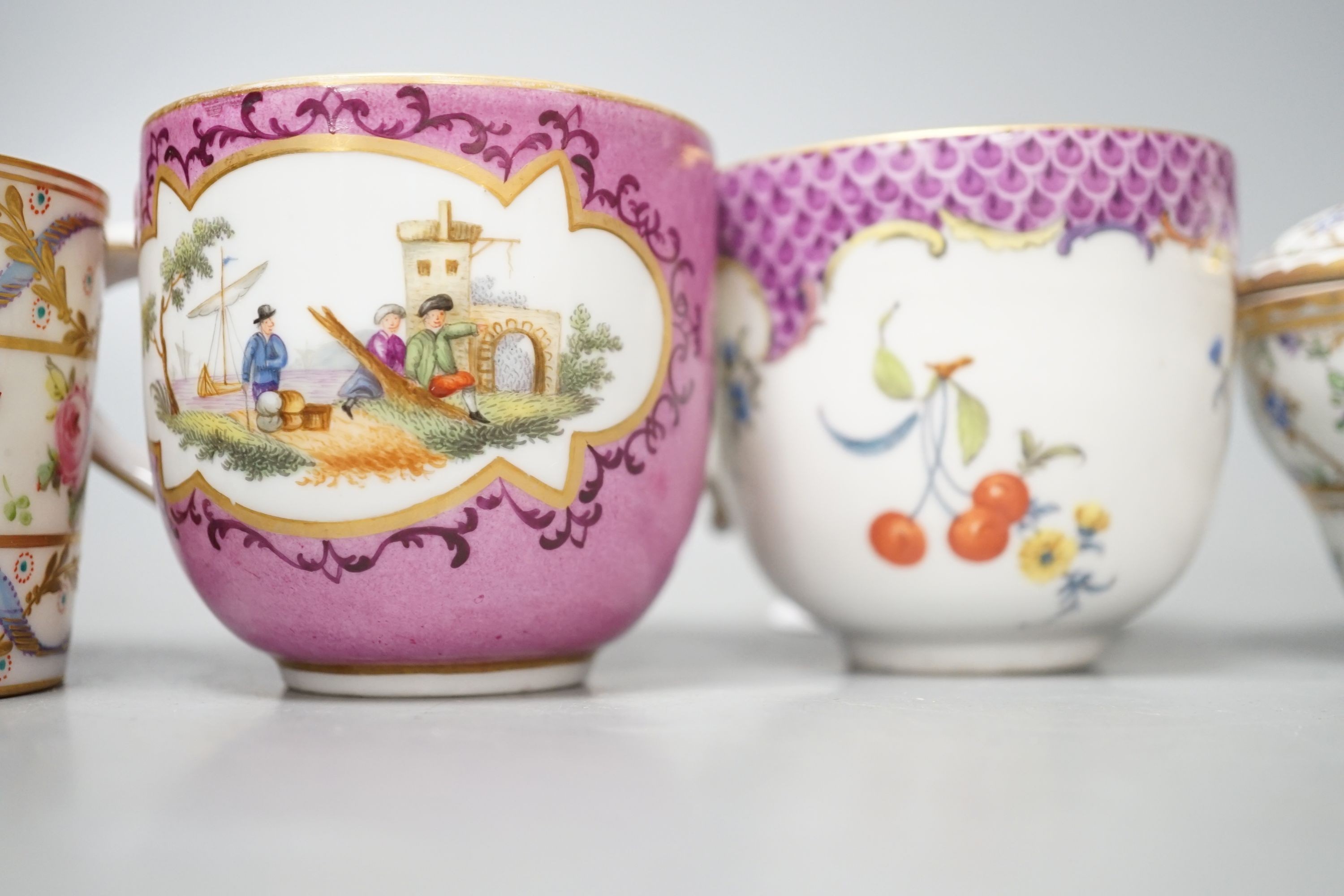 An 18th century Meissen pink ground coffee cup with entwined handle painted on two sides with a figural landscape on a pink ground, a 19th century French box and cover painted with flowers, a German coffee cup with pink